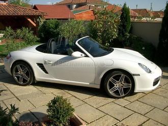 Fehér kabrió. Az autó kitölti a teret a képen, de teljes egészében látszik rajta. 